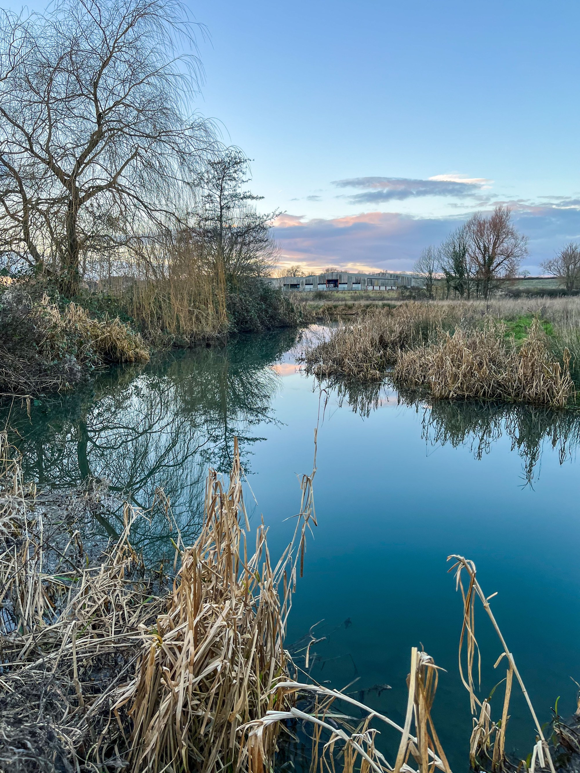 A peaceful English rural waterway at dusk